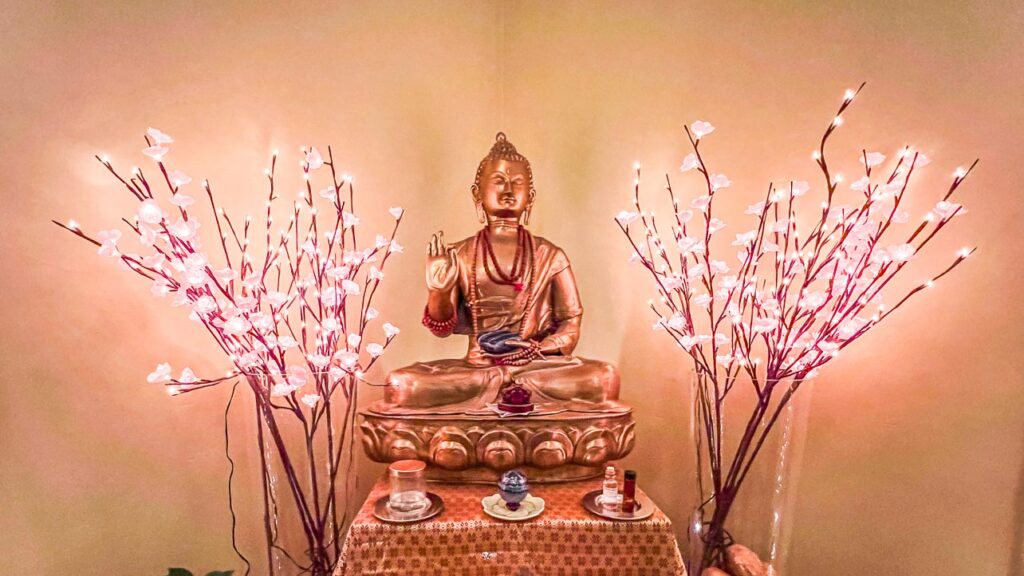 A golden Buddha in front of an altar